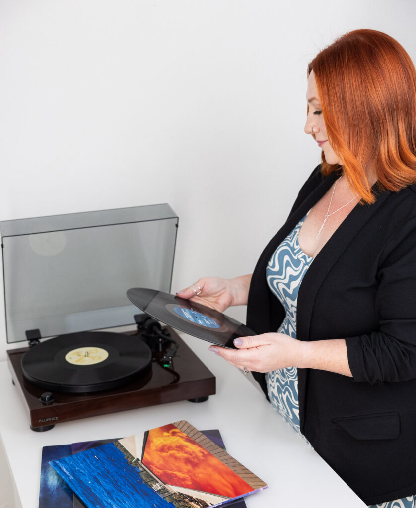 RaeAnn owner of Stout Bookkeeping putting a record on her record player