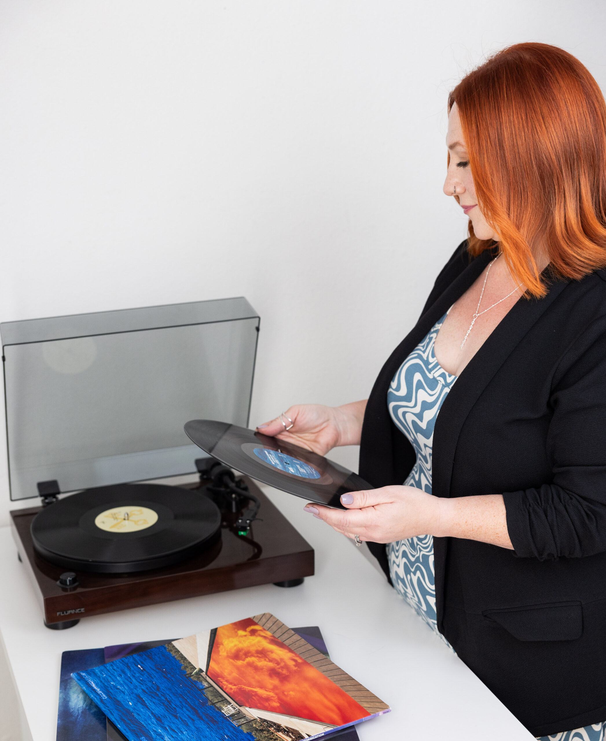 RaeAnn owner of Stout Bookkeeping putting a record on her record player